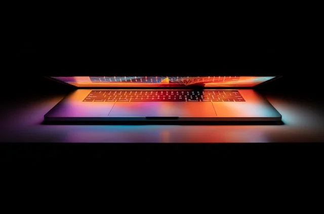 Laptop lit by a vivid gradient, representing enterprise hardware and software