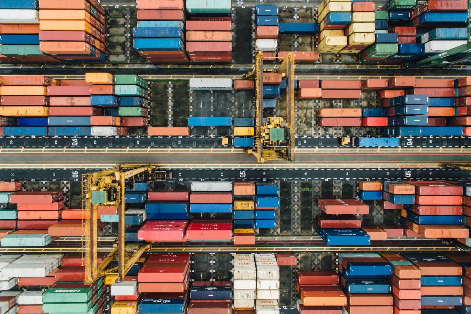 Aerial view of stacked shipping containers at a port terminal