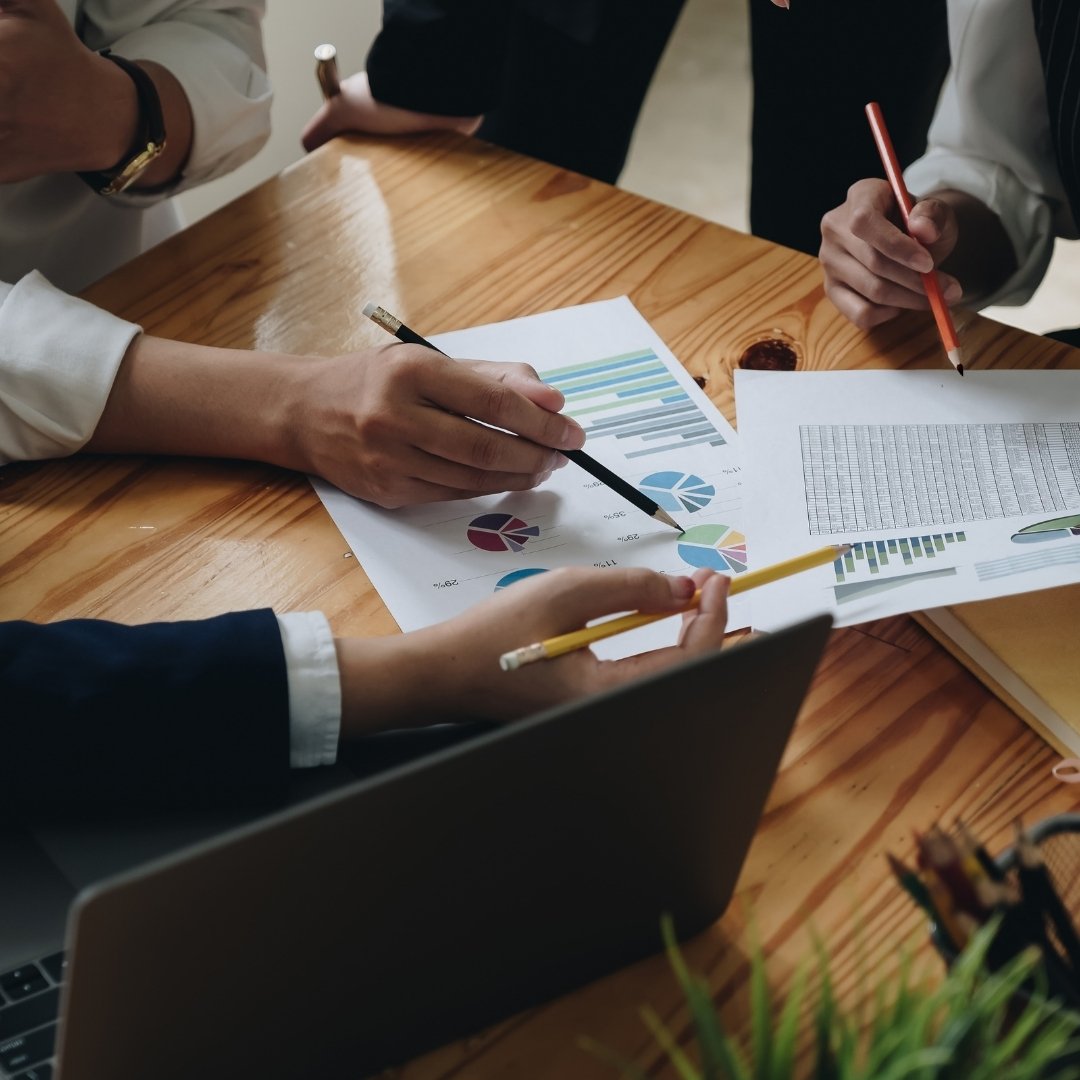 Advisors reviewing shipping documentation across a meeting table