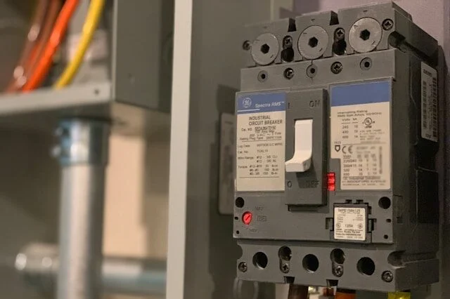 Industrial circuit breakers mounted in a power distribution panel